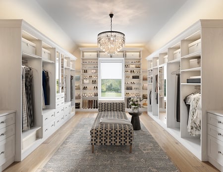 Create custom shoe storage Shoe organizing shelving In a walk in closet with cabinets, LED lighting and central seating by California Closets Gulfport & Hattiesburg Mississippi