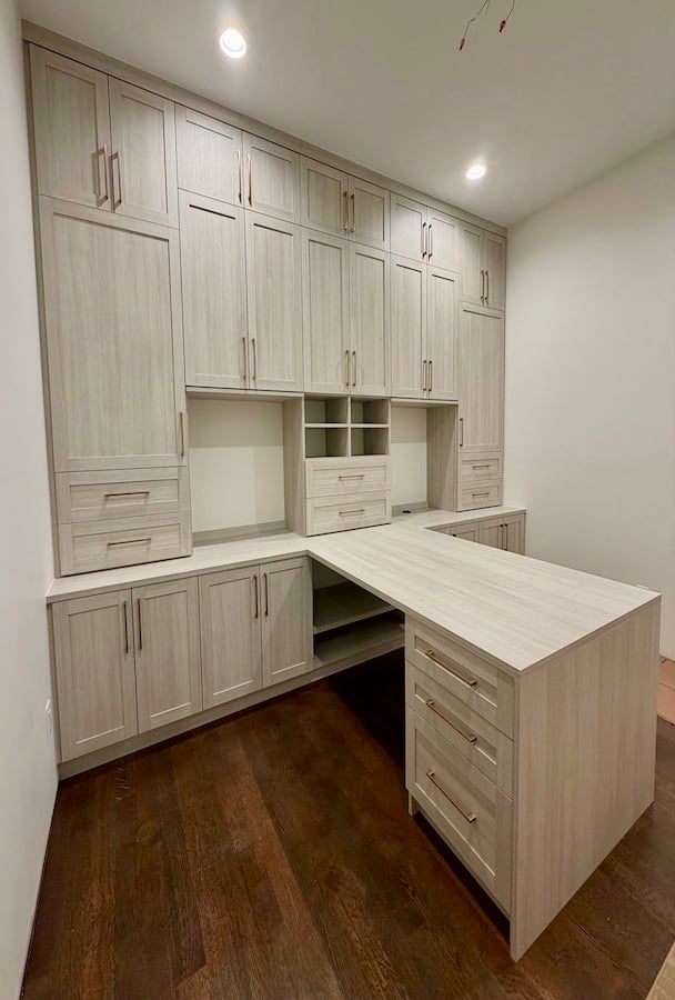 Perfect at Home Office! Custom craft room storage system featuring built-in cabinets, custom closets, drawer organization, shelving, and a multifunctional workspace island. This home office and crafting storage solution includes floor-to-ceiling cabinetry, closet organization, and custom storage systems designed for functional home organization by California Closets.