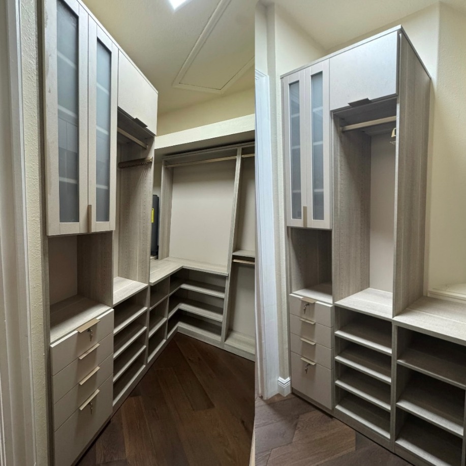 Refined Primary Closet Custom primary closet in Pietra and Stone with gold finger pulls and fluted rods.