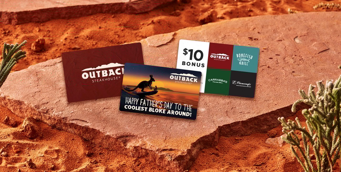Three Outback gift cards on a rock.
