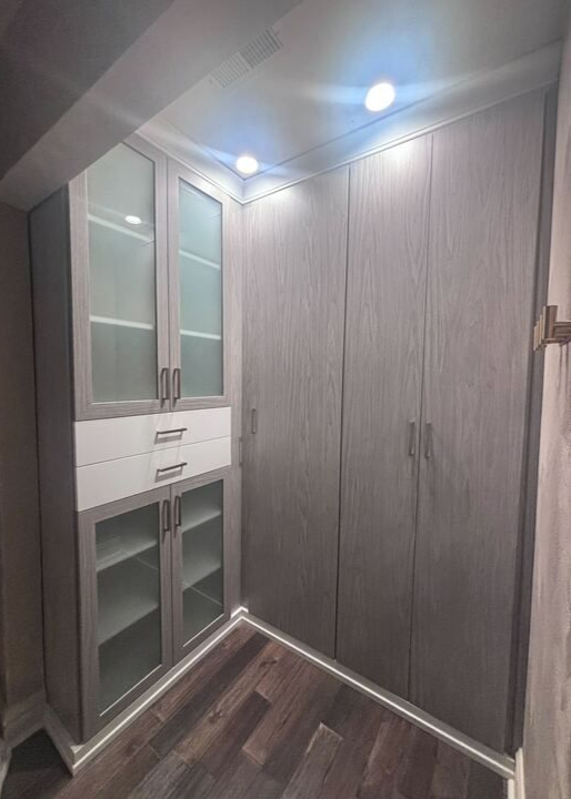 Style in Every Detail Virginia Beach – Custom wardrobe – Built-in wardrobe with glass doors, drawers, and integrated lighting