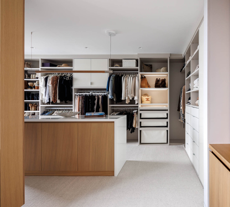 Two-Toned Walk-in Closet Img 1 - California Closets Westchester County New York Full Room Dressing Room Walk-in White and Natural Wood Closet with Center Island Storage for Hanging Shelving and Drawers