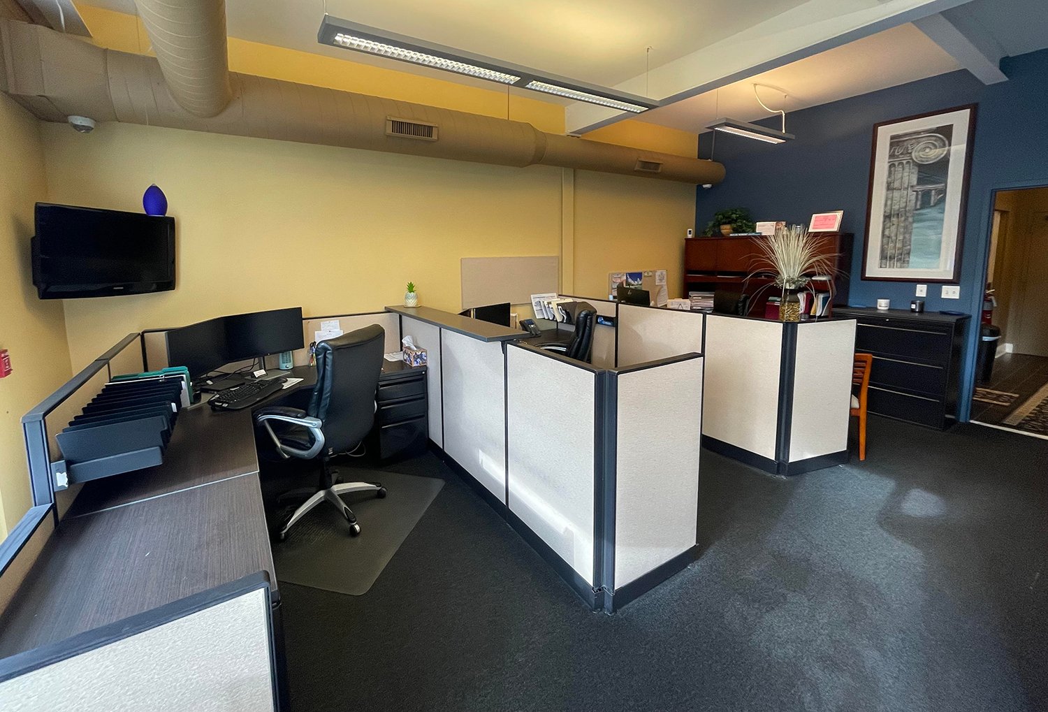 A few desks inside our agency, including Lori's desk