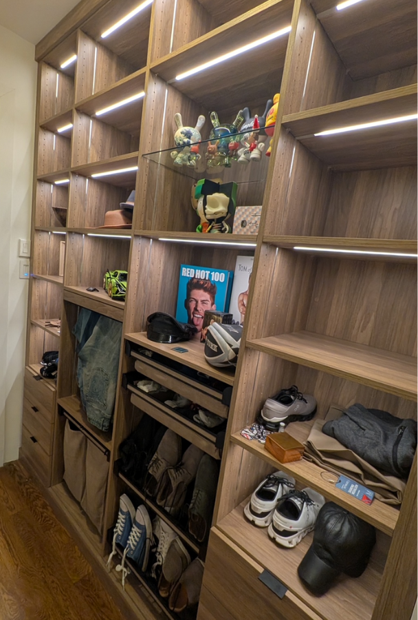 Custom Dark Wood Walk-in Closet California Closets Nassau County Long Island NY Custom Natural Wood walk in closet with LED strip lighting shelving for accessories and personal items, glass shelving, custom pants drawer organizer