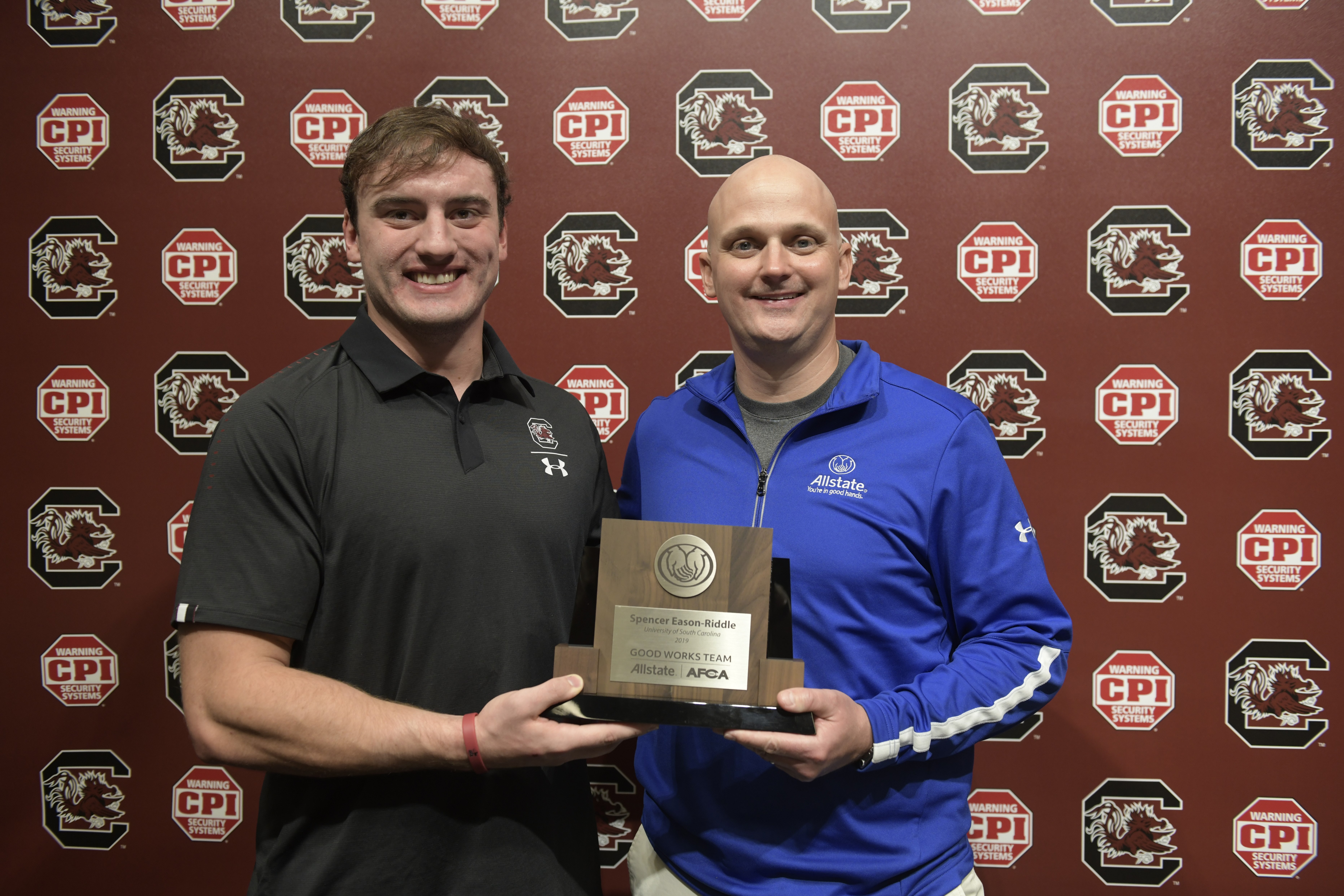 Presenting Spencer-Eason Riddle the Allstate Good Works Team trophy.