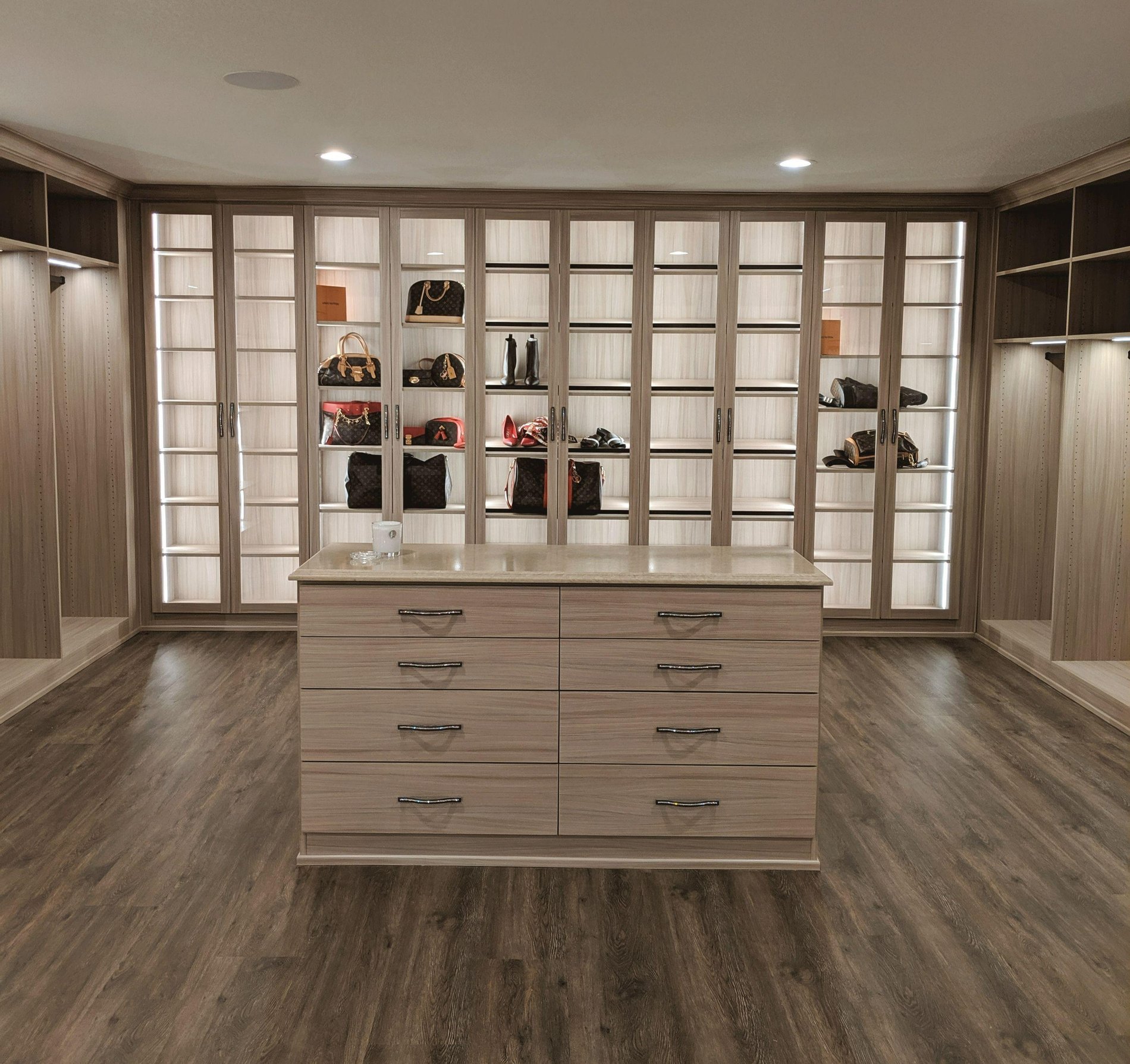 Sleek Closet with Shoe and Purse Shelving Luxe walk-in closet with backlit shoe shelving and center island