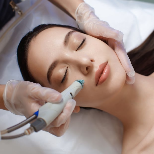 woman-receiving-HydraFacial-at Woodhouse-The-Woodlands