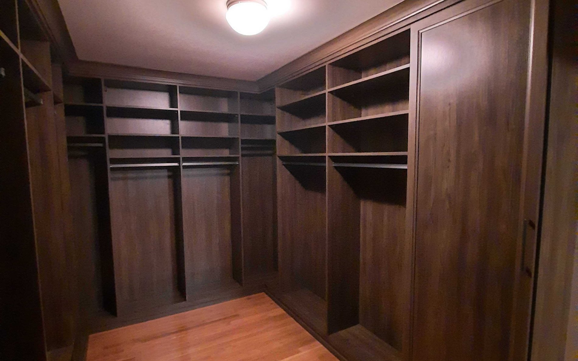 Traditional Walk-in Closet dark brown wood walk-in closet