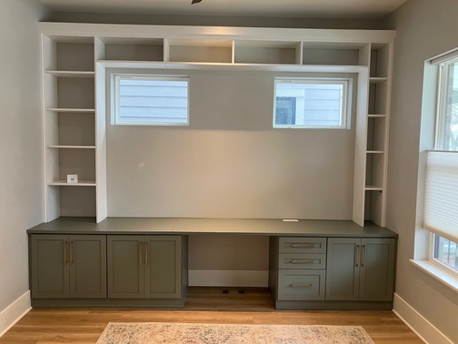 Home Office Custom home office with cabinets, shelving, and drawers for optimal storage and space.