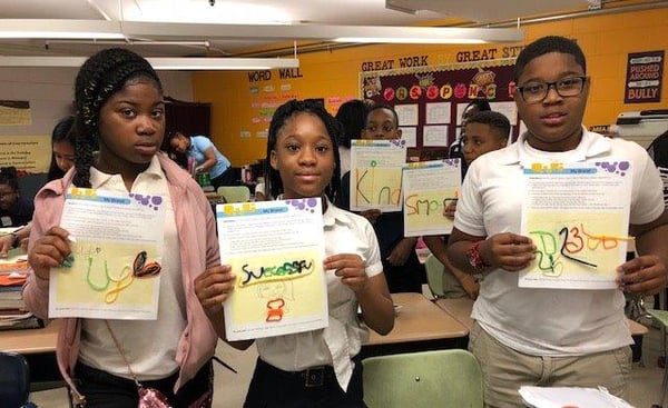 A group of students posing with their art works.