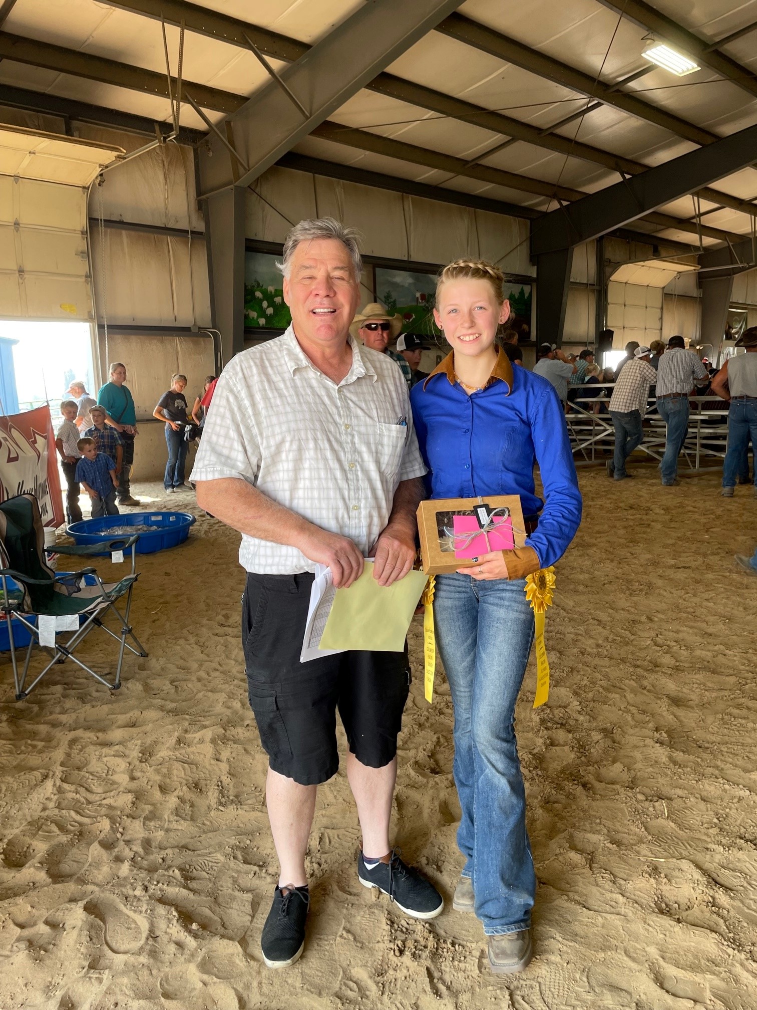 Richard Miller Insurance Agency supports local 4-H by purchasing this young lady's lamb at the Columbia Basin Junior Livestock County Sale.