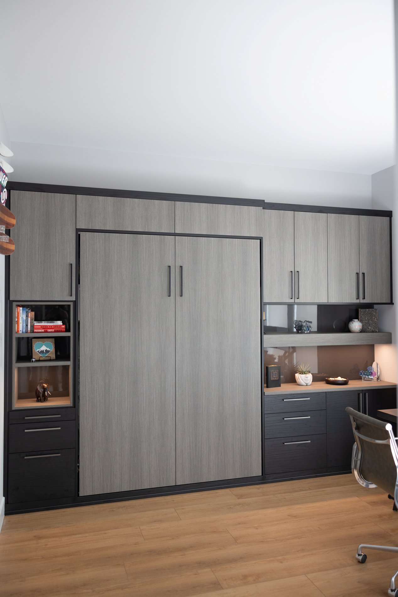 Grey Murphy bed with plenty of storage Murphy bed with built in lighting, two tone cabinetry offering plenty of storage