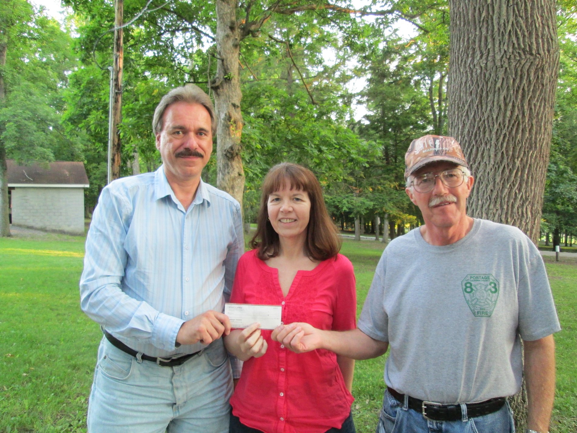 Duaine Detrick (Allstate agency owner) presents a $1,000 Allstate Foundation Hands in the Community Grant check as a volunteer to Portage Area Recreation Commission.