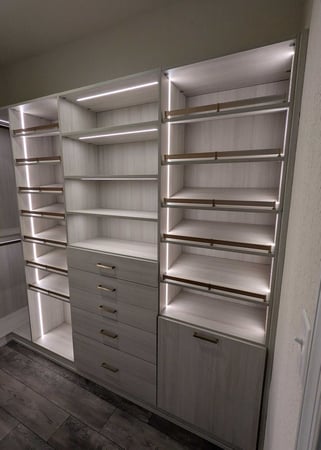 Virginia Beach - Custom closets - Elegant custom closet with integrated lighting, open shelving, and gold hardware.