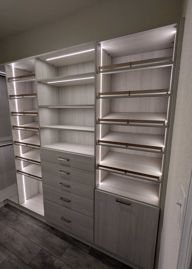 Virginia Beach - Custom closets - Elegant custom closet with integrated lighting, open shelving, and gold hardware.