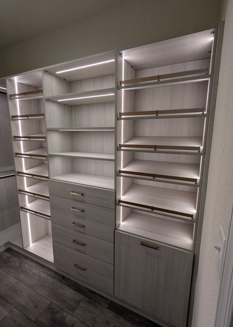 Virginia Beach - Custom closets - Elegant custom closet with integrated lighting, open shelving, and gold hardware.