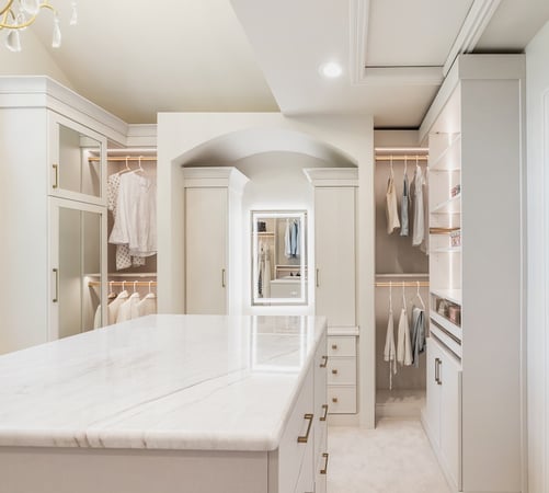 Luxury custom walk in closet with closet systems, closet cabinets, island drawers, vanity, and closet organization in Troy, Michigan by California Closets Greater Detroit