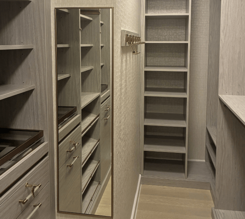 California Closets New York City Designer Lea Nardi custom walk in closet luxury walk in closet gray closet his and hers pull out mirror gold hardware hooks for purses scarves hats shoe storage jewelry drawers glass countertop drawer storage