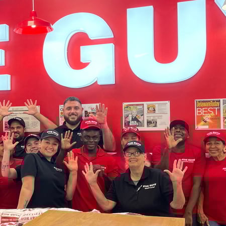 Crew members pose for a photograph in the dining room ahead of the reopening of the Five Guys restaurant at 7335 Radio Road in Naples, Florida.