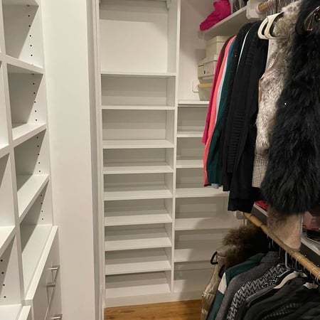 Floor-to-ceiling shoe shelves paired with built-in drawers.