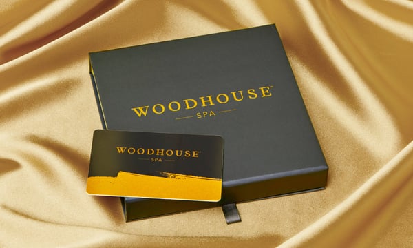 Woodhouse Spa gift card with gold draped background