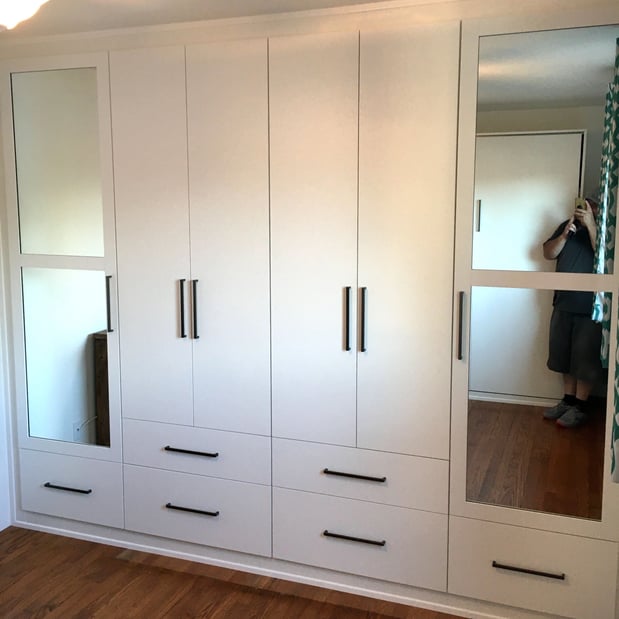 White storage cabinets and mirrored  doors