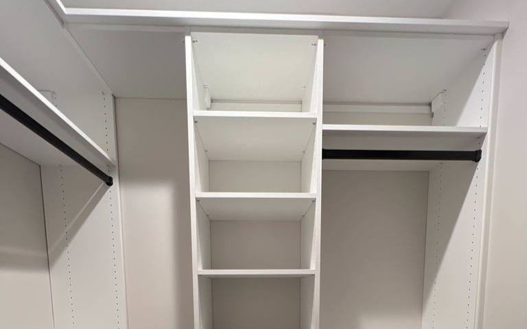 Shelving and hanging racks for hallway walk-in closet.