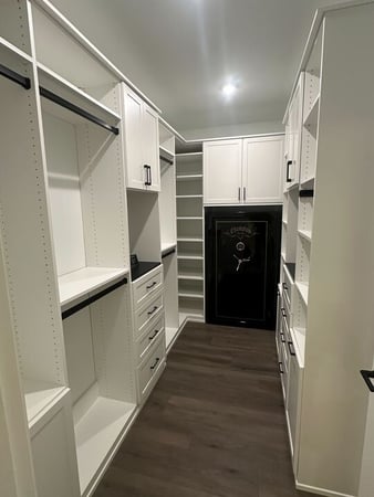 Custom Primary Closet with drawers, shelving, and doors.