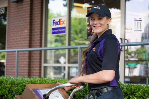 FedEx courier in front of FedEx Authorized ShipCenter