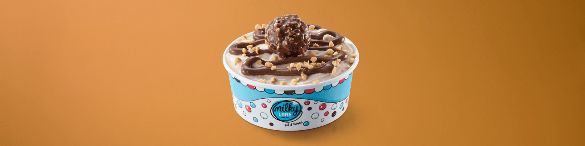 An ice cream tub drizzled with Ferrero Rocher® chocolate sauce and topped with a Ferrero Rocher® ball.