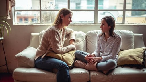 image of parent and child on couch