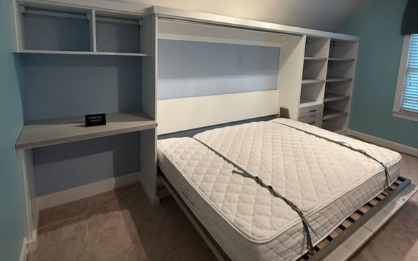 Wilmington - Custom closets - Bedroom wall unit with pull-down Murphy bed and integrated shelving.