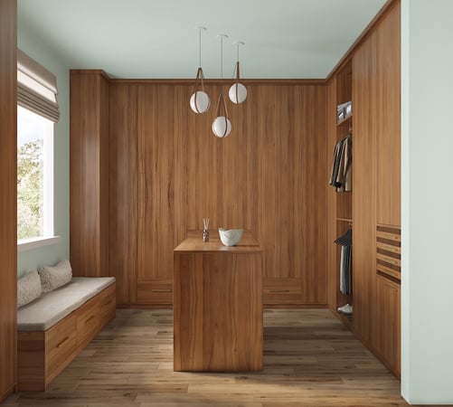 Warm wood walk in closet with custom cabinets, center island, and closet systems for organized storage solutions