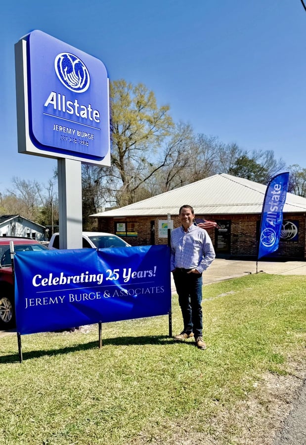 Jeremy standing by his 25 years sign.