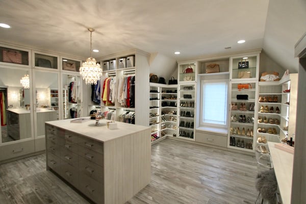 Luxury walk-in closet with vanity and wall of shoe shelving.