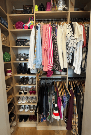 California Closets New York City small reach in closet organization custom closet with shelving and double hanging purse organization shoe organization custom closet custom reach in wood closet