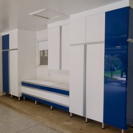 Custom Garage with white and blue acrylic cabinets