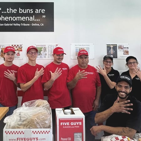 Crew members pose for a photograph ahead of the reopening of the Five Guys restaurant at 7110 Roger Avenue in Fort Smith, Arkansas.