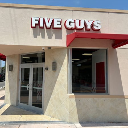 Exterior photograph of the Five Guys restaurant at 1540 South Dixie Highway in Coral Gables, Florida.