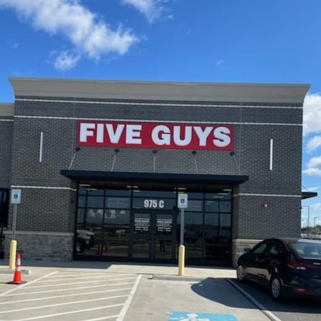 Exterior photograph of the Five Guys restaurant at 975 South Amity Road in Conway, Arkansas.