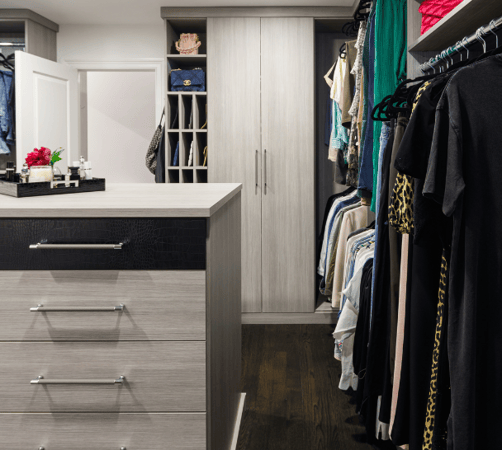 California Closets Nassau County Long Island NY Custom Luxury Walk in Closet Dressing Room Gray Closet Center Island Leather Drawer Faces Silver Hardware Closed and Open Door Storage Hanging and Cubby Storage