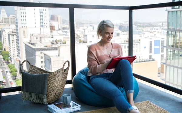 Women on balcony using fiber internet with her tablet