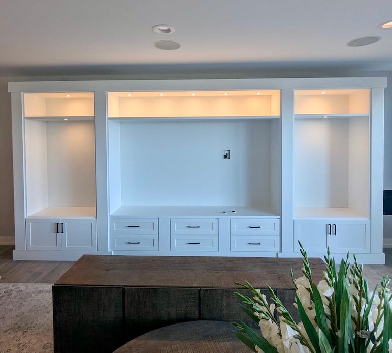 Built-in media center with custom cabinets, integrated drawers, and living room storage. Boyne City, Michigan
