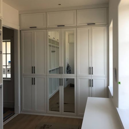 Richmond - Custom closets - White walk-in closet with cabinets and mirrors
