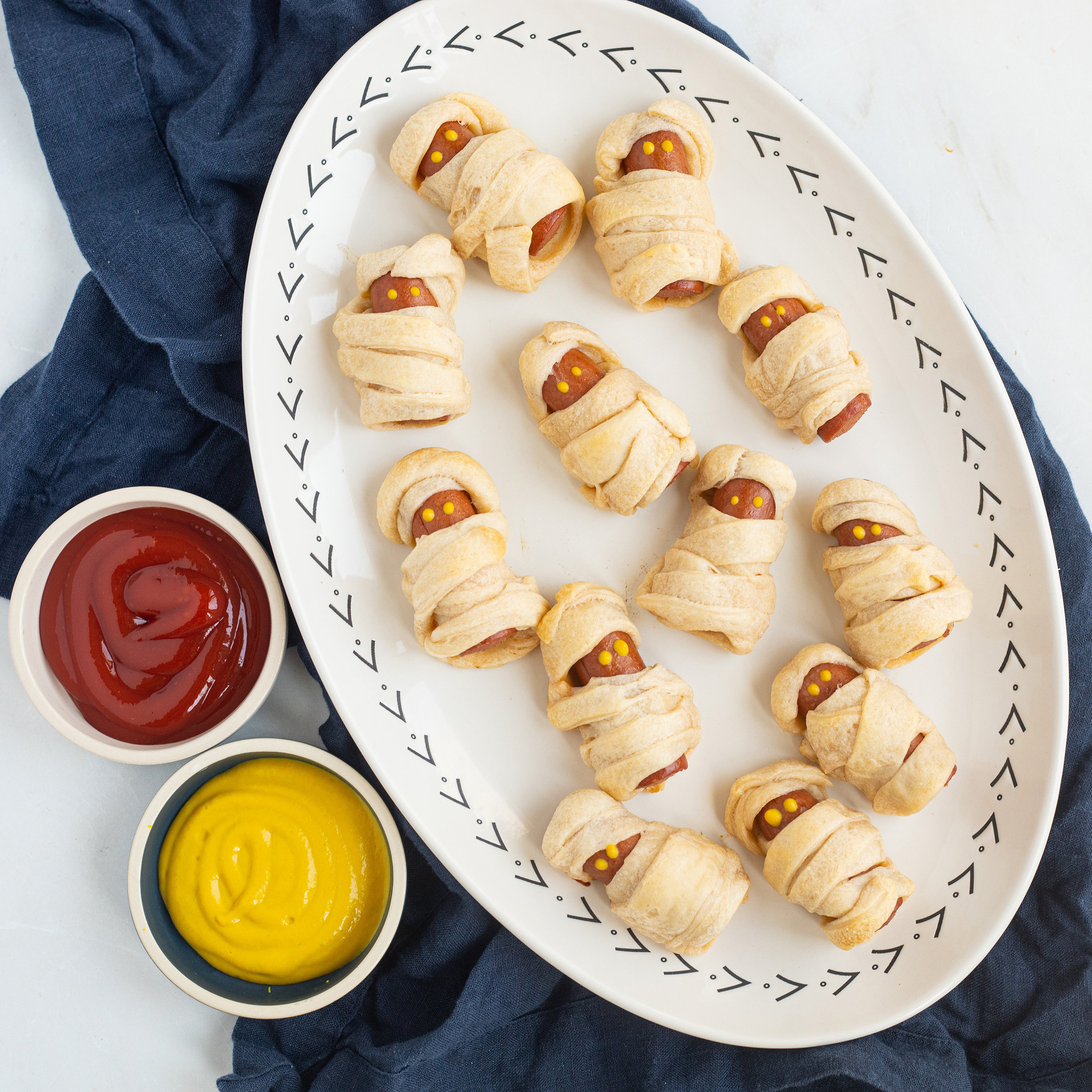 hot dog crescent roll mummies with ketchup and mustard