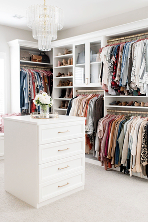 Luxe white walk-in closet with center island