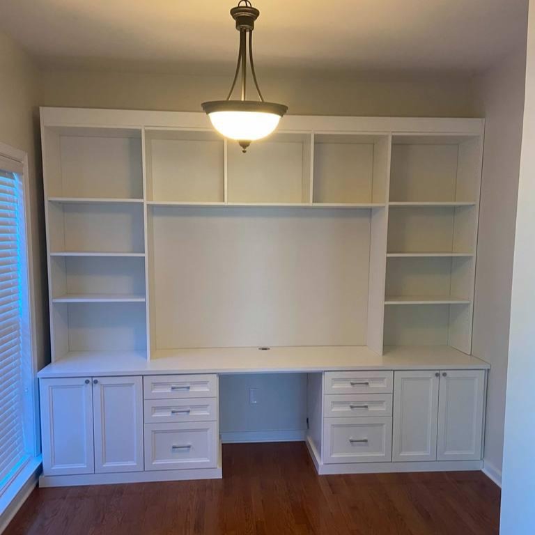 Richmond - Custom closets - White entertainment center with shelves and drawers surrounding a cutout for a tv