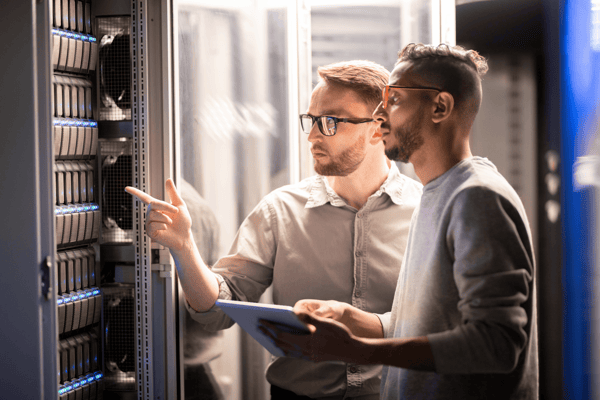 Men talking in front of a server