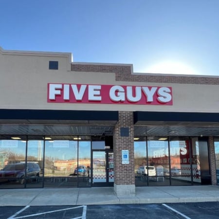 Exterior photograph of the Five Guys restaurant at 5808 Wilmington Pike in Centerville, Ohio.