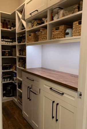 Pantry with built-in wall shelving, cabinets, drawers, and countertop.